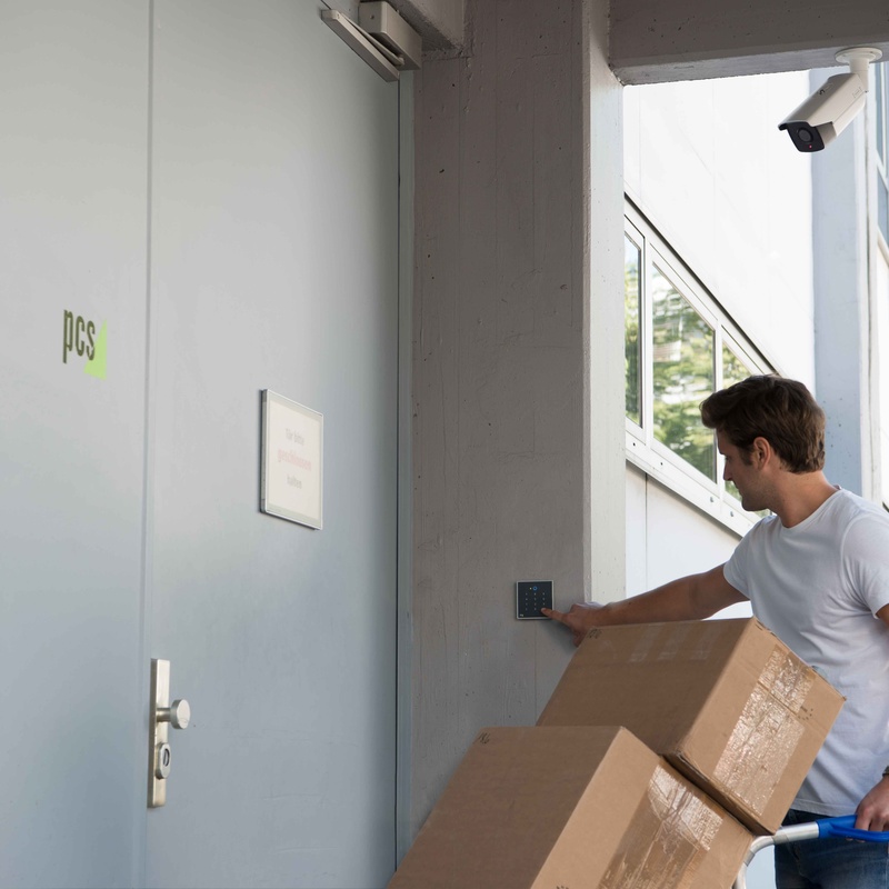 Paketlieferant vor videoüberwachter Türe